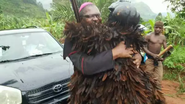 Excited Masquerade Poses With Catholic Priest After Meeting Him On The Road (Photos)